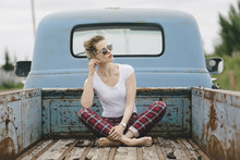 Blond Girl  Wearing Sunglasses In The Back Of A Pickup Truck Int