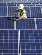 © Hugh Sitton/Stocksy - Technician working on solar panel