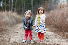 Stylish And Cute Young Children Holding Hands
