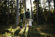 © Koen Meershoek/Stocksy - Young family walking through the forest in Sweden.