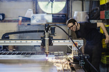 Young Working Man Supervising Plasma Cutting Machinery