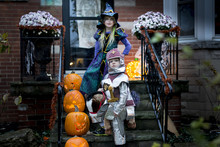 Children Dresses As Knight And Witch For Halloween Trick Or Treat
