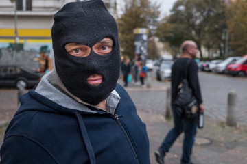 Unrecognizable masked man looking to the camera. Outdoors