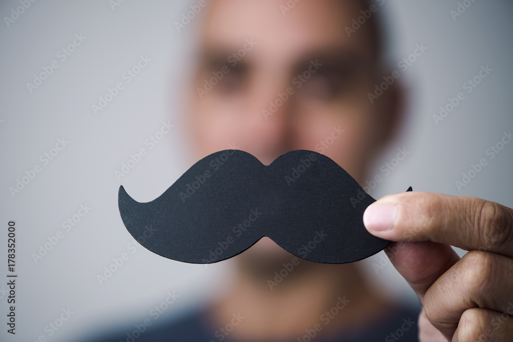 young man with a fake moustache - obrazy, fototapety, plakaty 