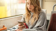 © guruXOX - Young girl uses a mobile phone in the city bus