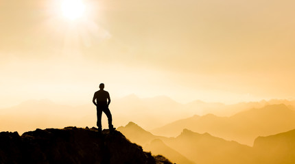 Poster - Man reaching summit enjoying freedom and watching towards mountain ranges.