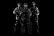 © andy_gin - Three soldiers in uniform with a weapon in their hands are looking menacingly.