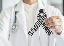 Carcinoid Cancer Awareness Ribbon Zebra Stripe Black And White Pattern Symbolic Bow Color On Doctor’s Hand Support