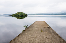 Concrete Jetty At A Lake With The Island Of Innisfree