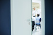 © pressmaster - Business seminar or lecture taking place behind slightly open door of boardroom