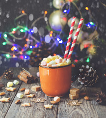 Wall Mural - a cup of Christmas hot cocoa with marshmallow New Year's lights and decorations, selective focus