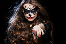 Beautiful Woman With Halloween Sugar Skull Makeup Pointing Her Finger At You. I Want You! Gesture. Close Up Studio Portrait. 
