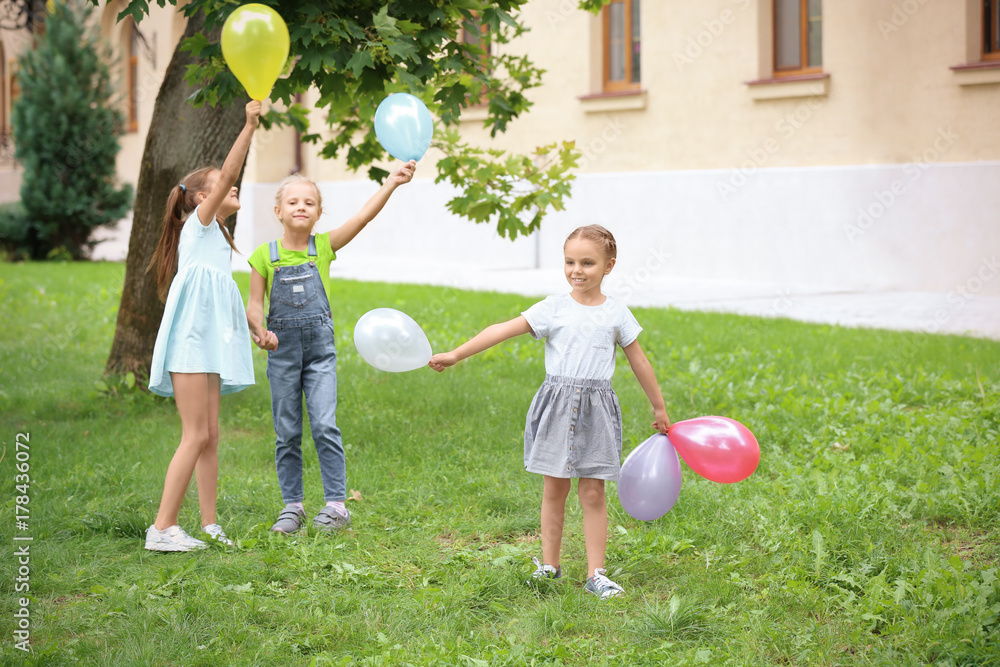 Cute little children playing in green park