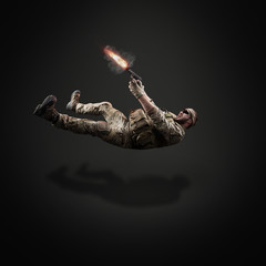 USA Army soldier with fired gun (motion effect).  Shot in studio on black background. Action concept