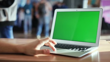 global information tehcnology development innovation new age hitech man hand using touchpad notebook close up green screen mockup chromakey blurred public space people background 3g online working pc