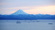 fishing boats in the Bay with the volcano in autumn on Kamchatka.