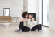© .shock - happy multiethnic couple  in front of fireplace