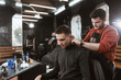© artpodporin - shave neck/ Barber cutting in barbershop. Shaves the man's neck with a blade