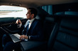 © alfa27 - Serious businessman in a car with laptop