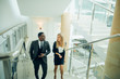 © alfa27 - Businessman and Business woman walking up stairs with bags to office.
