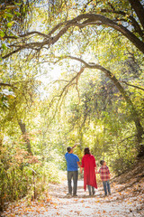 Wall Mural - Mixed Race Caucasian and Hispanic Family Taking a Walk At The Park.