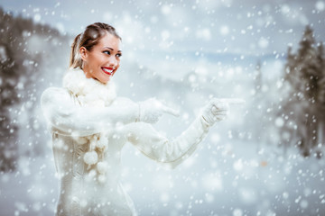 Wall Mural - Girl In Winter Clothes Pointing Away