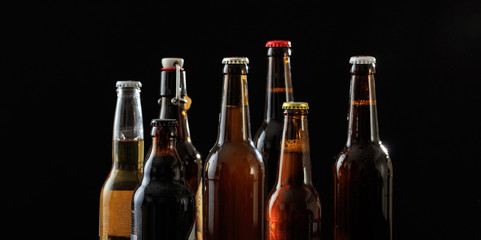 Set of beer bottles on black background