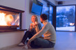 © .shock - happy couple in front of fireplace