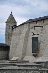 Wall Mural - Tower of the Pskov Kremlin and Dovmontov town - ancient stone ruins