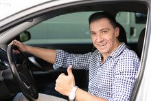 Happy Man Sitting In New Car And Showing Thumb Up