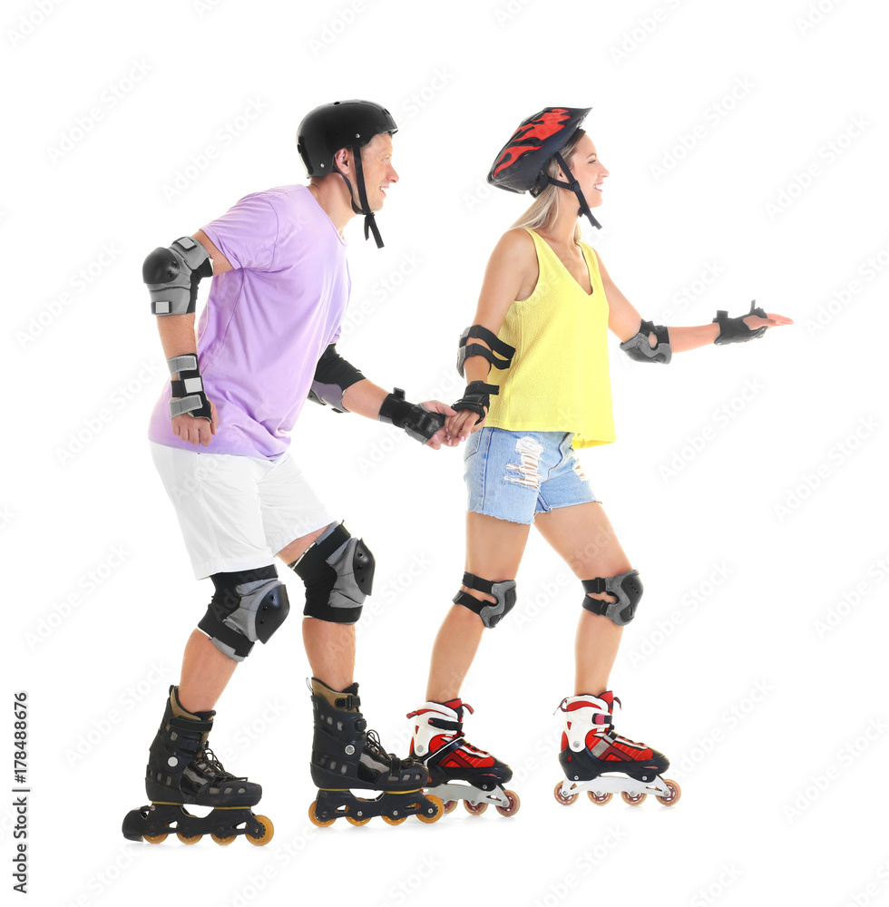 Couple on roller skates against white background