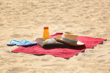 Canvas Print - Summer composition with red beach towel on sand