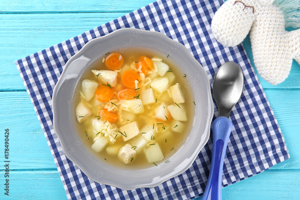 Plate of delicious baby soup on table