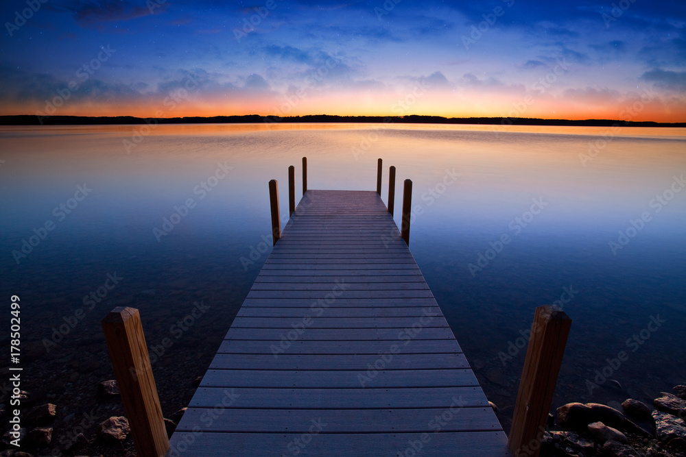 Relaxing view of dock going out onto Torch lake in northern Michigan - obrazy, fototapety, plakaty 