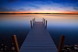 Fototapeta  - Relaxing view of dock going out onto Torch lake in northern Michigan