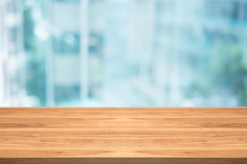 Wall Mural - Empty wood table top on blurred background at office building,copyspace for montage your products