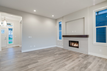 Interior of a modern living room with hardwood floors and fireplace.