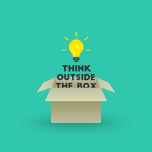 Think Outside The Box Concept With Bright Lightbulb And Text Emerging Out Of Cardboard Box