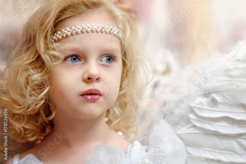 Beautiful Little Girl Angel Has Long Curly Hair And Blue