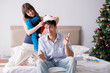© Elnur - Young happy family celebrating christmas in bed