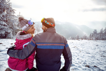 Wall Mural - couple in love enjoying on winter vacation together on the mountain