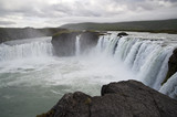 Fototapeta Tęcza - Wonderful view of Gadafoss Falls in a typical Icelandic landscape, a wild nature of rocks and shrubs, rivers and lakes.