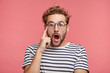 © wayhome.studio  - Studio shot of atractive fashionable hipster guy keeps mouth opened, being amazed by shocking news, isolated over pink background. Shocked stylish bearded man wonders, wears striped clothes.