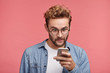 © WHstudio Leushin N - Shocked stylish hipster guy reads news online, uses free internet connection on modern cell phone, finds out about car accident in neigbour strict. Astonished male model recieves strange message