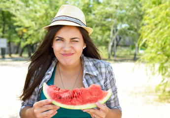 Wall Mural - Happy young woman eating watermelon on the beach. Youth lifestyle. Happiness, joy, holiday, beach, summer happiness concept.