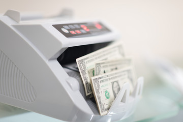 banknote counter is counting usd (us dollars) banknotes