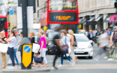 Poster - Piccadilly circus with lots of people, tourists and Londoners crossing the junction. Red bus at the background. Blurred type image. London, UK