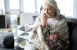 Senior lady suffering from flue at home