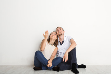 Couple looking up, sitting on floor