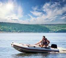 Man On An Inflatable Motor Boat